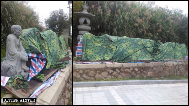 被拆除的罗汉像堆在路旁用布遮盖
